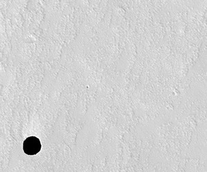 Initial image of hole on the side of Arsia Mons, Mars seen by the HiRISE instrument on Mars Reconnaissance Orbiter. CREDIT: NASA/JPL/University of Arizona