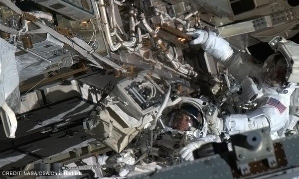 Astronauts Chris Cassidy and Tom Marshburn repair an ammonia coolant leak on the outside of the International Space Station, 400 kilometres above the Earth's surface. CREDIT: NASA/CSA/Chris Hadfield May 2013 Extra